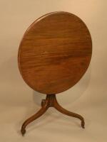 A mahogany tilt top occasional table