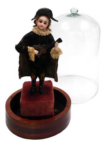 A late 19thC Tete Jumeau musical automaton, possibly designed by Leopold Lambert, modelled as a boy standing wearing black velvet breaches and jacket with lace trim, and a cloak trimmed with lace around the collar, and a tricorn hat, playing a guitar, rai