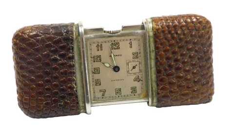 A Movado Ermeto pocket purse watch, rectangular silvered dial bearing Arabic numerals, subsidiary seconds dial, in a snakeskin bound stainless steel case, no 505925, 5.5cm wide.