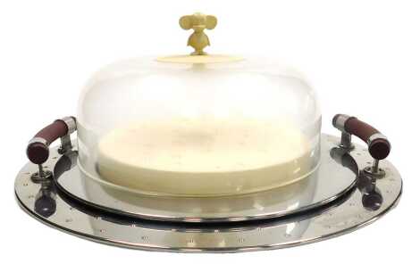 An Alessi twin handled circular tray, designed Michael Graves, with brown resin handles, 48cm wide, together with an Alessi cheeseboard cover and stand, designed by Michael Graves, the cover with mouse finial, 28cm wide. (2)
