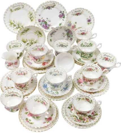 Twelve Royal Albert porcelain Flower of the Month series trios, comprising Snowdrops, Cosmos, Chrysanthemum, Violets, Christmas Rose, Michaelmas Daisy, Forget-Me-Not, Roses, Sweetpea, Anemones, Poppy and Lily of the Valley, with boxes, together with a Lav