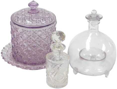 A late 19thC glass fly trap, with stopper, 19cm high, together with a cut glass scent bottle and stopper, and an amethyst cut glass biscuit barrel, cover and stand. (3)
