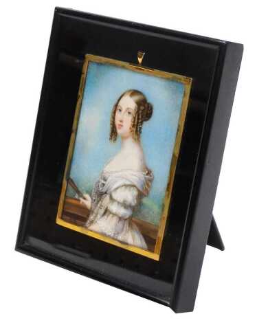 English School (early 19thC). Half length miniature portrait of a lady holding a fan, watercolour, framed and outer strut framed, 9.5cm x 7cm.