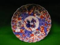 An Imari platter, late 19thC, circular with wavy edge, painted with radiating