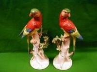 A pair of German porcelain figures of parakeets