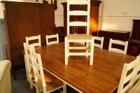 A superior pine topped dining table and 10 heavy beech chairs finished in cream.