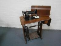 A Singer oak cased treadle sewing machine.