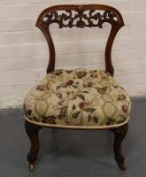 A Victorian carved walnut nursing chair