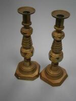 A pair of large brass ejector candlesticks