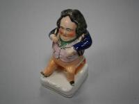 A 19thC Staffordshire figure of 'A pinch of snuff'