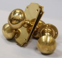 *Various pairs of brass door knobs.