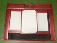 *A red leather desk cover and jotter