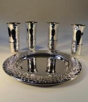 A set of four Gucci white metal drinking cups and associated tray