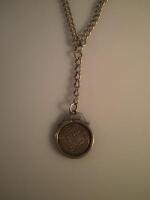 A coin pendant on silver chain