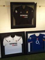 Three framed football shirts