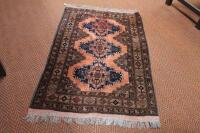 A red ground Persian rug with three central medallions