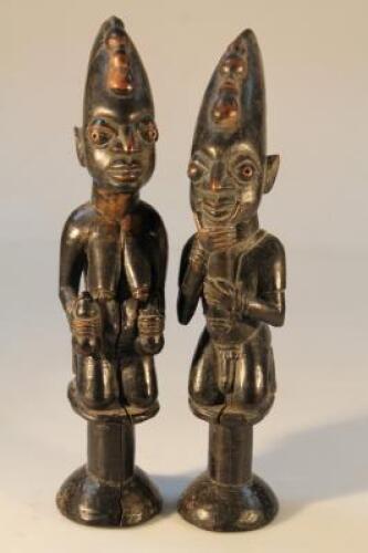 Tribal Art. A pair of African carved hardwood figures of a man and woman kneeling on a plinth. (AF)