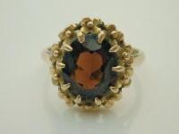 A 9ct gold garnet set dress ring