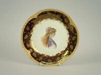 A German porcelain plate printed centrally with a female in profile wearing elaborate jewellery