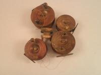 Five early 20thC and later mahogany and brass fishing reels