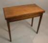 An early 19thC oak and mahogany cross banded fold over tea table