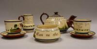 A Torquay pottery motto ware oversized tea set