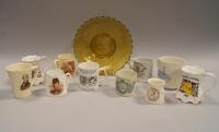 A collection of commemorative mugs and glass.