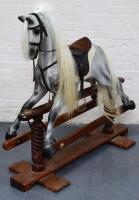 A modern dapple grey rocking horse