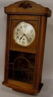 A 1930s oak wall clock