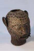 Tribal Art. A cast metal stylized head of a humanized leopard