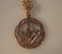 A 9ct gold Masonic fob suspended on an unmarked yellow metal chain