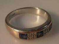 A sapphire and tiny diamond set dress ring