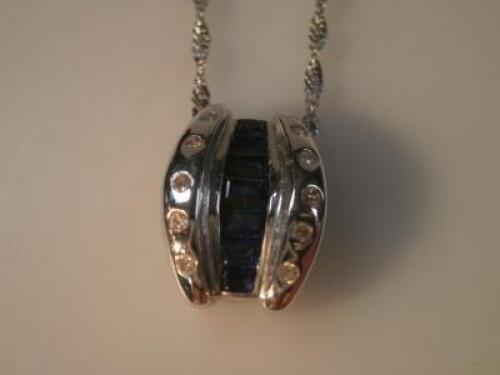 A diamond and sapphire set pendant