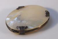 A mother of pearl folding handled magnifying glass