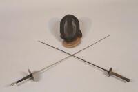 Two fencing foils and a fencing mask. (3)