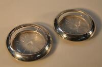 A pair of American sterling silver and cut glass wine coasters