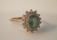 A 14ct gold emerald and diamond cluster ring