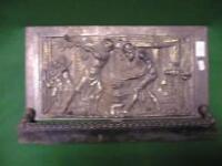 A Coalbrookdale panel and stand depicting a blacksmith scene