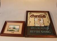 A framed Coco Cola advertising mirror