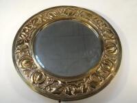 An Arts & Crafts style hammered brass framed circular mirror