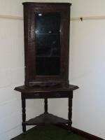 A 19thC carved oak corner cupboard