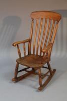 A 19thC slat back rocking chair.