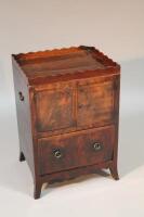 A early 19thC mahogany pot cupboard on bracket feet