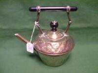 A brass tea kettle with flower chased decoration and bakelite handle and finial