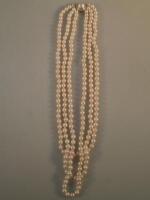 A long single row cultured pearl necklace with 9ct gold clasp