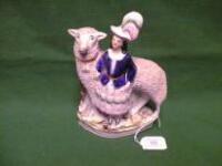 A Staffordshire figure of a girl and sheep