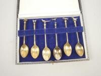 A set of six sporting related silver gilt teaspoons