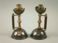 A pair of 19thC Arts and Crafts style candlesticks