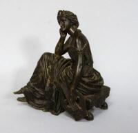 A 19thC French bronze figure of a seated neo classical female holding a harp