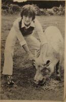 A postcard picture of John Lennon with a pig.